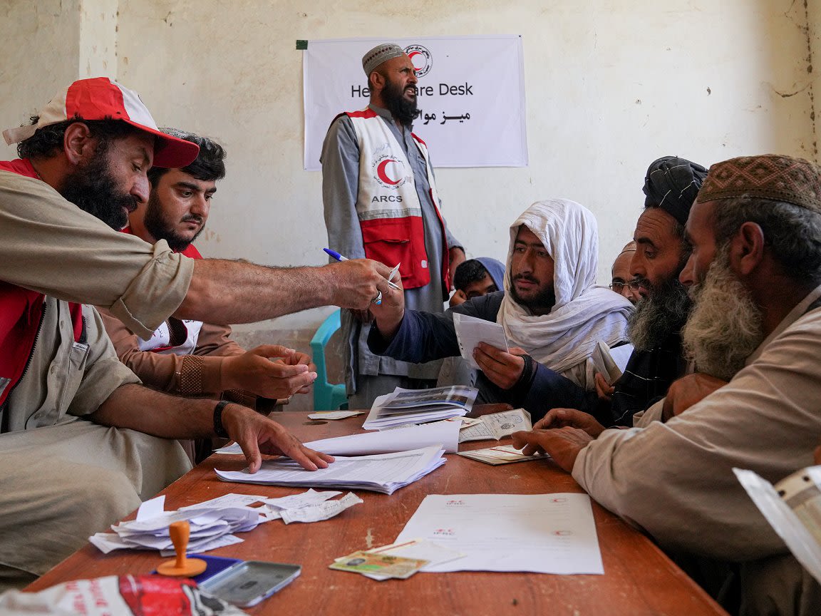 Chronic drought in Afghanistan got more publicity and had wider impacts in 2022, but here Afghan Red Crescent personnel provide cash relief to people affected by unseasonal floods – an example of compound impacts dominating the contemporary policy agenda for humanitarians. 